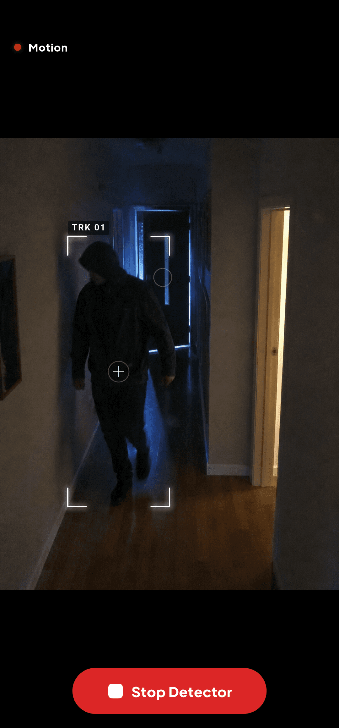 The Intrude watch screen at night, with the tracker's brackets closed on a person walking down a hallway.